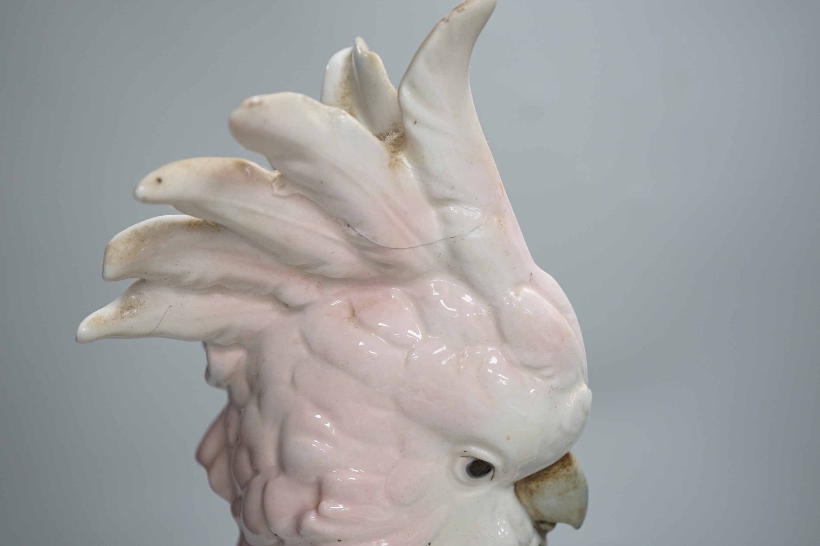 Two Royal Dux parrots and a Beswick parrot, the largest 40cm high